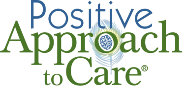 Logo for "Positive Approach to Care," featuring a peacock feather, brain graphic, and vibrant colors, symbolizing a holistic care philosophy.